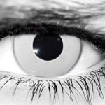 Person wearing white-out Prescription Zombie Contacts with special FX makeup
